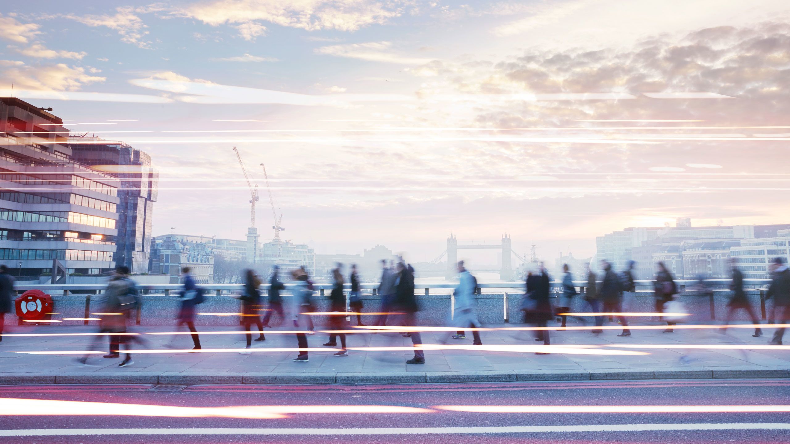 Business people walking through the city at dawn.