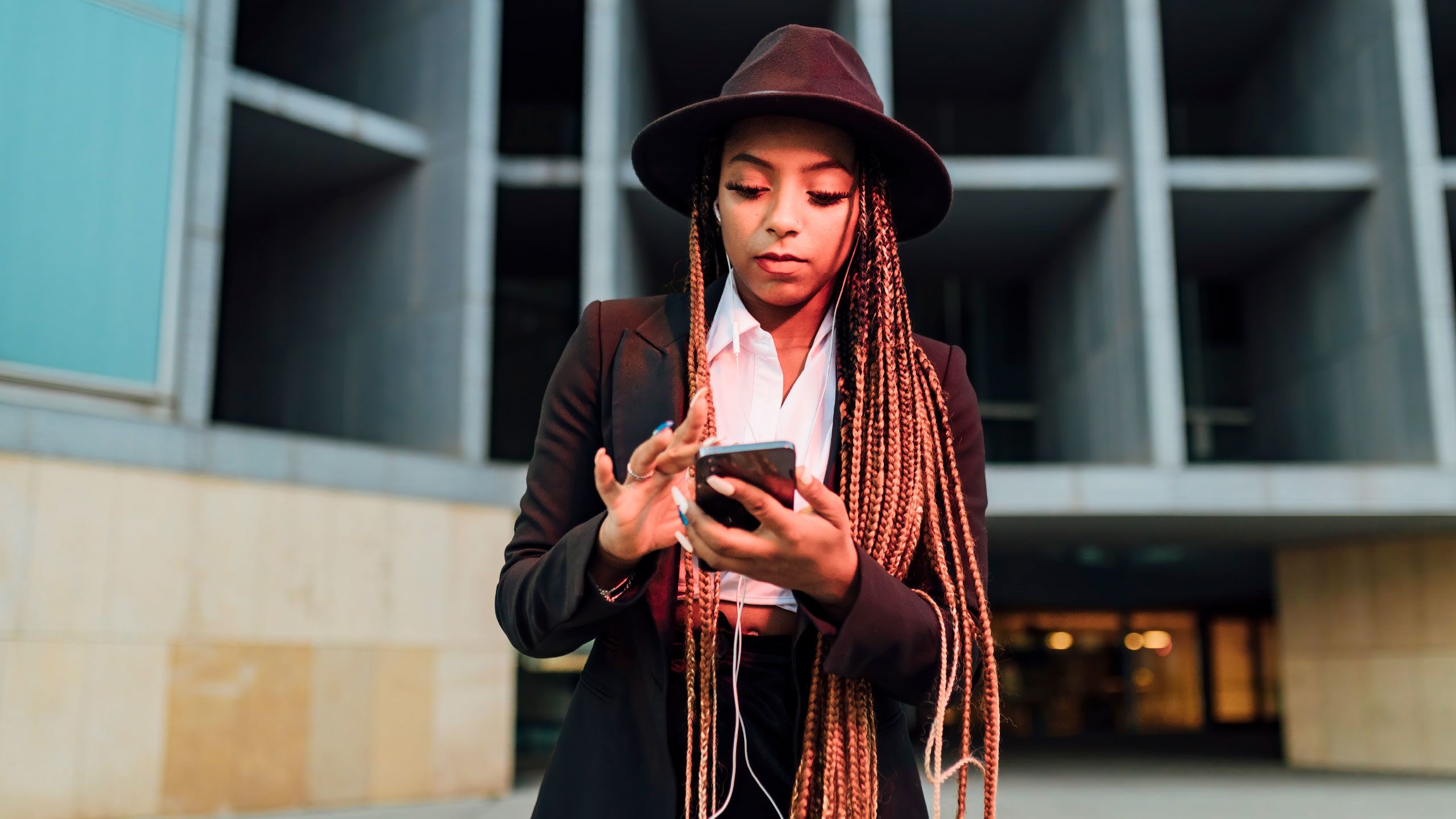 Young woman standing against built structure